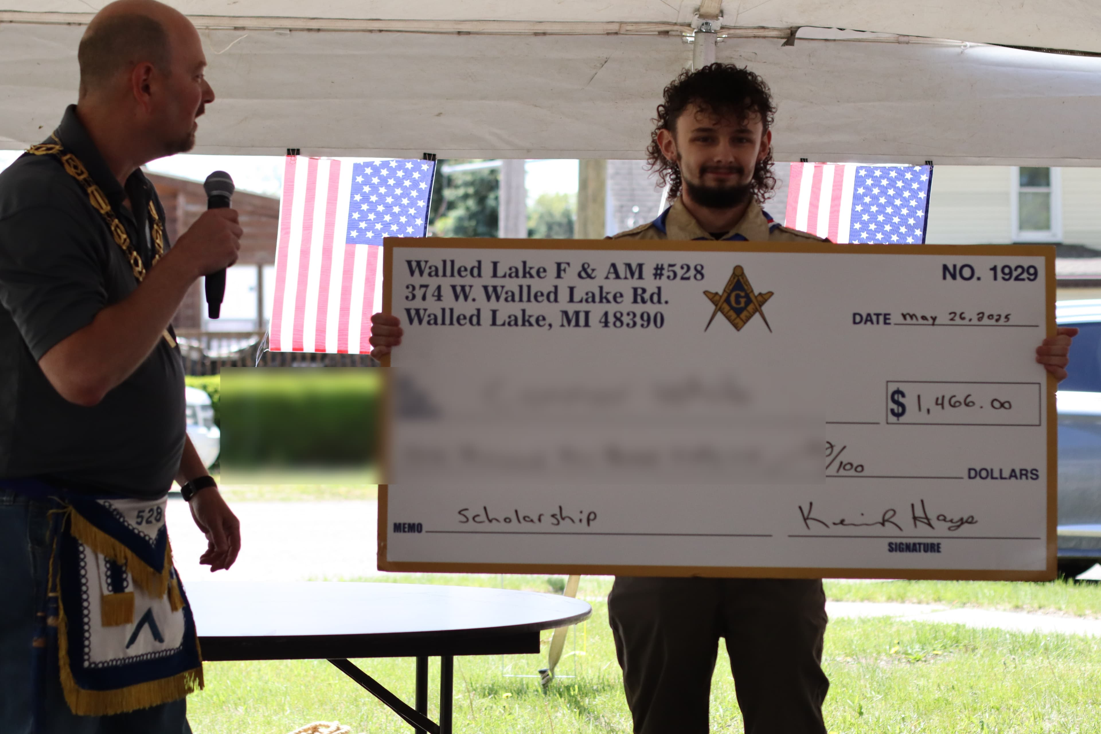 Lodge presenting a scholarship award to a community member